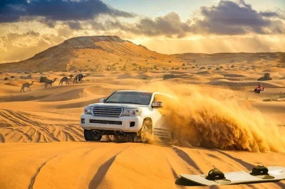 Feel the rush of dune bashing in dubai’s desert, try sandboarding, ride camels, and unwind at a bedouin camp with bbq dinner and live performances. includes pickup.