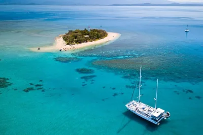 Step onto a sailing catamaran from port douglas to low isles for reef snorkeling, glass bottom boat rides, and a tropical buffet lunch—includes marine biologist guide.