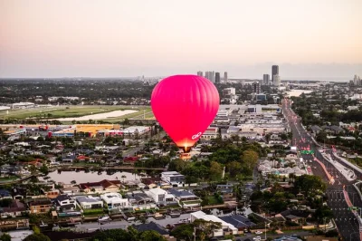 Float above the gold coast at sunrise in a spacious hot air balloon, with easy wheelchair access, photo package included, and early morning pickup.