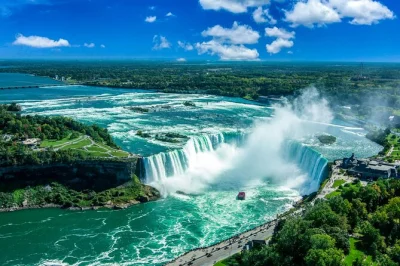 Feel the spray on a maid of the mist boat ride, explore niagara falls state park with a bilingual guide, and enjoy round-trip travel from new york city. includes pickup.