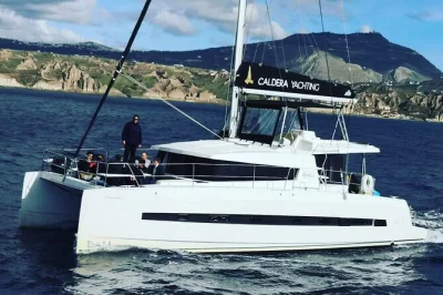 Feel the wind on a santorini catamaran cruise—swim at red & white beach, soak in volcanic hot springs, enjoy bbq lunch onboard. includes hotel pickup.