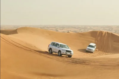 Feel the thrill of dune bashing in qatar’s desert, ride a camel, try sandboarding, and gaze at the inland sea—includes airport pickup and local tea.