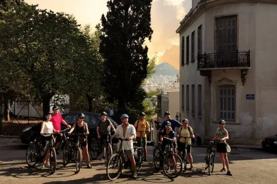 Catch the golden hour in athens by bike, passing ancient sites and lively neighborhoods with a small group. includes bike, helmet, and english-speaking guide.