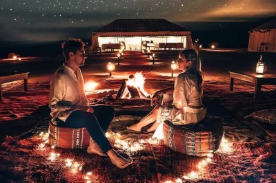 Feel the calm of agafay desert at sunset with a camel ride, berber camp dinner, and live fireshow. includes marrakech pickup and bottled water for comfort.