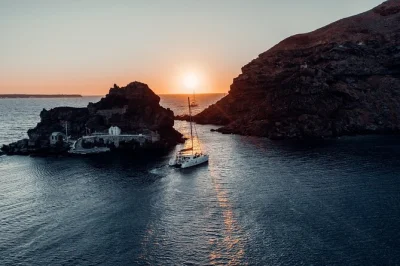 Feel the sea breeze on a santorini catamaran sunset cruise with bbq, open bar, hot springs swim, and hotel pickup—plus local wine and ouzo on deck.