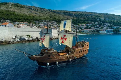 Step onto a wooden galleon in dubrovnik for a sunset cruise with live storytelling, drinks, and city views. includes welcome drink, wifi, and accessible boarding.