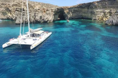 Feel the calm of malta’s coast on a catamaran cruise with swimming stops, fresh lunch, and drinks included. family-run, not crowded, with comino caves sights.