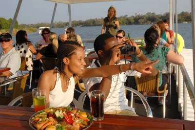 Experience a zambezi river sunset cruise with wildlife, plus a guided victoria falls rainforest tour. includes transfers, drinks, and local insights.
