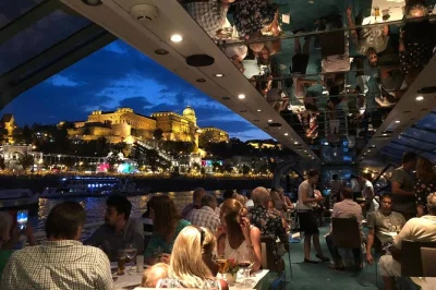 Float past budapest’s parliament, chain bridge & buda castle on a candlelit danube dinner cruise with live music. includes welcome drink, 4-course meal & night views.