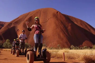 Wake up to sunrise at uluru, ride a segway around its full base, and walk to mutitjulu waterhole with a guide. includes hotel pickup, breakfast, and all gear.
