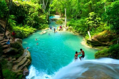 Feel the cool rush at jamaica’s blue hole, then drift on a bamboo raft through rainforest rivers near ocho rios. includes pickup, entry fees, and local drinks.
