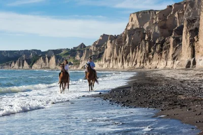 Feel the sea breeze riding horses along santorini’s black sand beach, with local guides, panoramic caldera views, and digital photos included in your day.