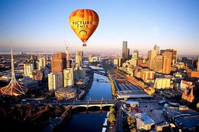Float above melbourne at sunrise in a hot air balloon, seeing the mcg, yarra river & city landmarks with private transport included. early morning adventure awaits.