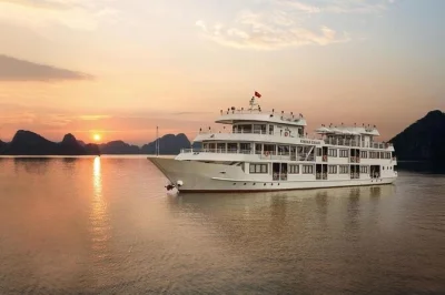 Sleep on a halong bay cruise from hanoi, kayak near limestone cliffs, explore surprise cave, and swim at titop island—includes transfer and meals.