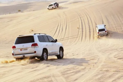Experience a private abu dhabi morning desert safari with camel rides, sand skiing, and dune bashing. includes bedouin camp visit and sunrise photos.