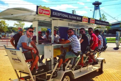 Ride through bratislava on a beer bike with friends, local guide, and all-you-can-drink draft beer. includes 90-minute city tour and pickup option.