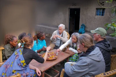 Experience rural rwandan life near volcanoes national park on a guided village tour. visit homes, help cook, and meet locals. includes bottled water.