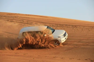 Experience a desert safari from abu dhabi with dune bashing, sandboarding, and a bbq dinner. includes hotel pickup, local guide, and cultural activities.