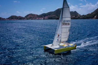 Sail the baie des saintes from guadeloupe with a local guide, try your hand at catamaran maneuvers, and swim in clear waters. includes refreshments.
