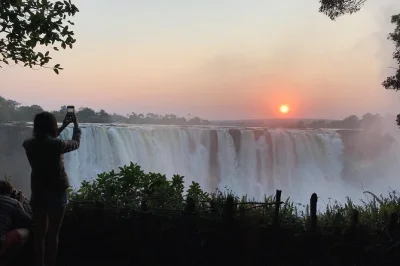 Experience victoria falls at sunrise on a guided walking tour with hotel pickup. capture photos, learn from a local expert, and see the falls in a new light.