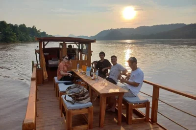 Drift down the mekong at sunset from luang prabang, then share a local hot pot dinner. includes pickup, slow boat ride, and local guide. book now.